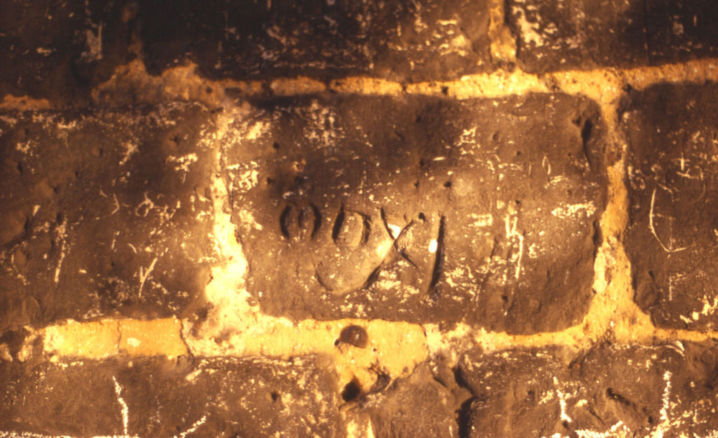 The Canons Dovecote, The Canons, Madeira Road, Mitcham, Surrey CR4. Dated stone block in the Dovecote wall : MDXI (1511) : date of erection ? Removed during cleaning in 1993.