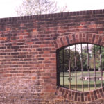 Location of boundary tablet on wall of Wandle Park, Colliers Wood, London SW19. Byegrove Road. rear of Newborough Court.