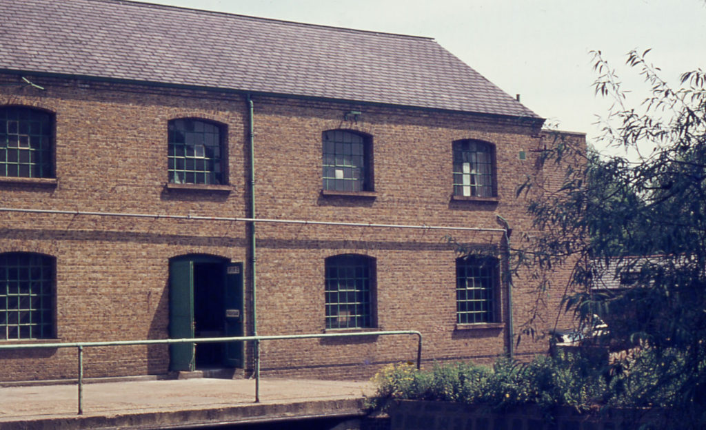 Grove Mill, Mitcham, Surrey CR4. Rebuilt about 1907-1908. Occupied by R. F. White & Co. (soap manufacturers) from the mid-50s to 1977. The building was converted to flats c. 2004.